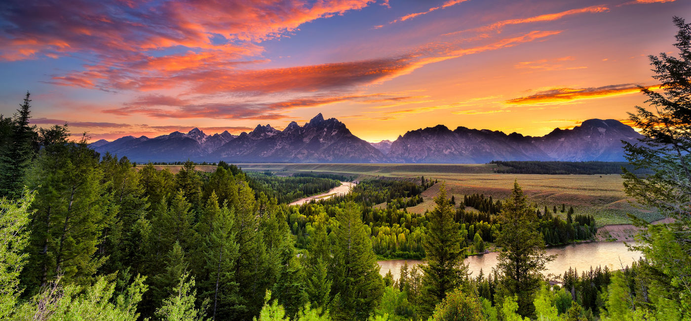 Image: PHOTO: Colorful sunset at Snake River Overlook in Grand Teton National Park, WY (photo via Dean_Fikar / iStock / Getty Images Plus)