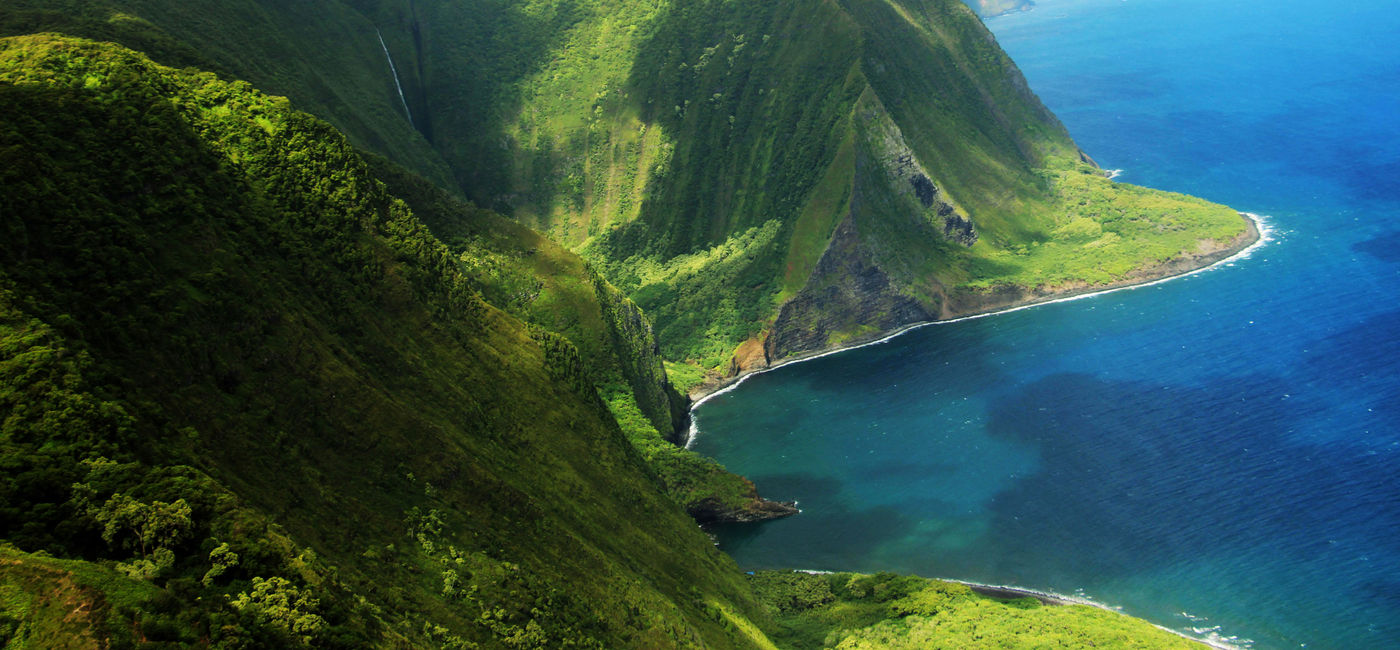 Image: PHOTO: Aerial view of the coast of Molokai island and Kahiwa Falls (Photo via VickyRu / iStock / Getty Images Plus)