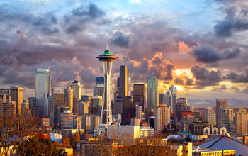 Seattle skyline at sunset, WA, USA (photo via dibrova / iStock / Getty Images Plus)