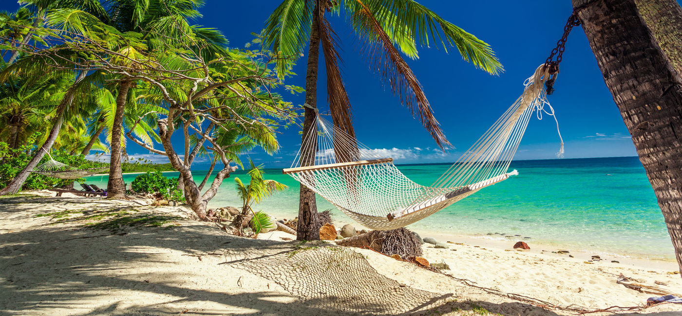 Image: Empty hammock in the shade of palm trees on tropical Fiji Islands. (photo via mvaligursky/iStock/Getty Images Plus) (mvaligursky / iStock / Getty Images Plus)