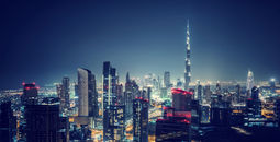 Beautiful Dubai cityscape, bird's eye view on a night urban scene, modern city panoramic landscape, United Arab Emirates (photo via Anna_Om / iStock / Getty Images Plus)
