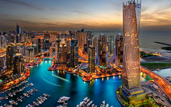 Dubai Marina from a high view showing the boats, sea, and the city scape. (photo via JandaliPhoto / iStock / Getty Images Plus)