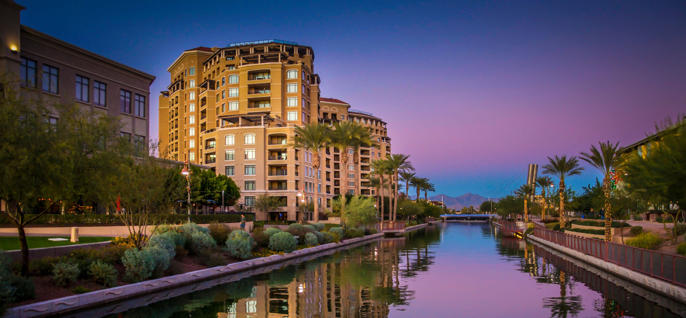 Image: Arizona Canal running through Scottsdale,Az,USA at sunset (photo via BCFC / iStock / Getty Images Plus)