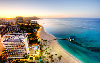 Sunrise at Waikiki Beach, Hawaii (photo via Andy_Tam / iStock / Getty Images Plus)