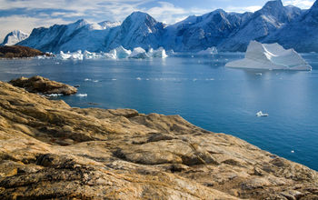 Northwest Fjord in the far reaches of Scoresbysund in eastern Greenland (photo via SteveAllenPhoto/iStock/Getty Images Plus)