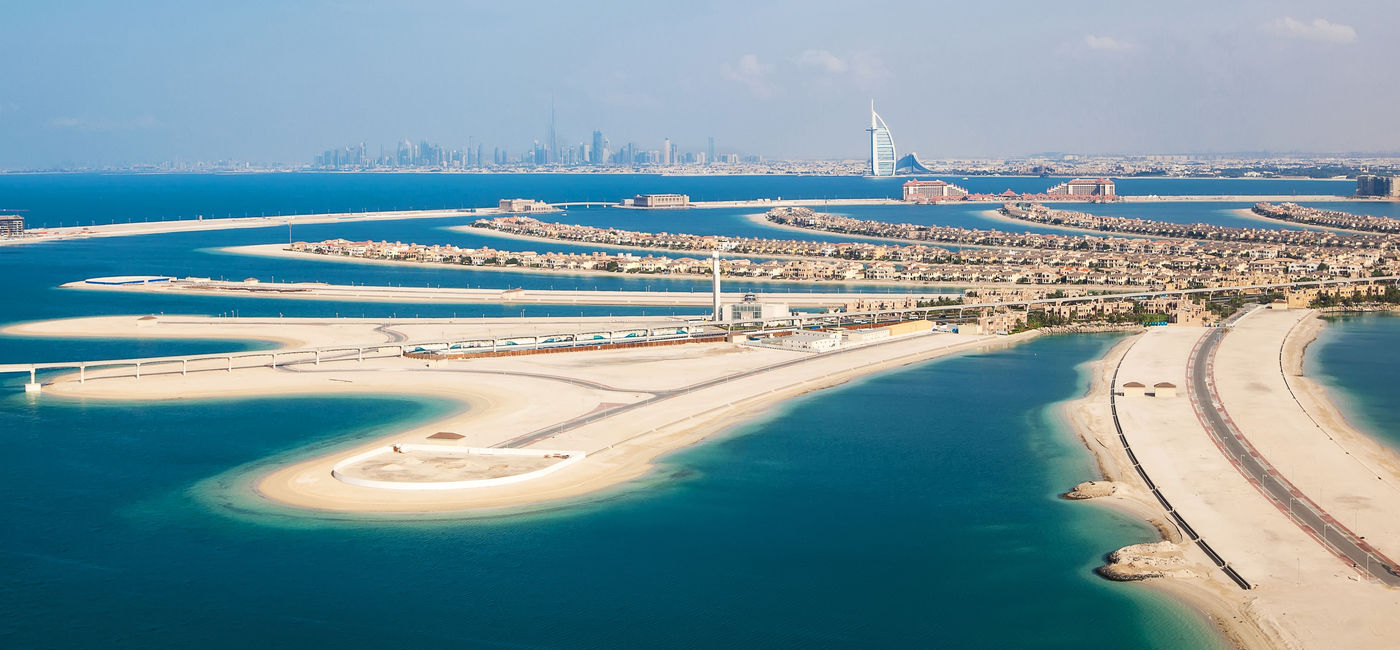 Image: PHOTO: Dubai, UAE. The Palm island from above. (photo via romrodinka / iStock / Getty Images Plus)