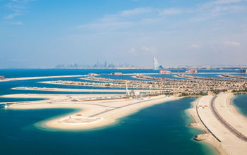 DUBAI, UAE - JANUARY 20: The Palm on January 20, 2011 in Dubai, UAE. The Palm is an artificial island with many luxury hotels and villas. Helicopter view (photo via romrodinka / iStock / Getty Images Plus)