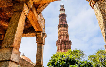 Qutub Minar Tower, Delhi India (photo via DVrcan / iStock / Getty Images Plus)