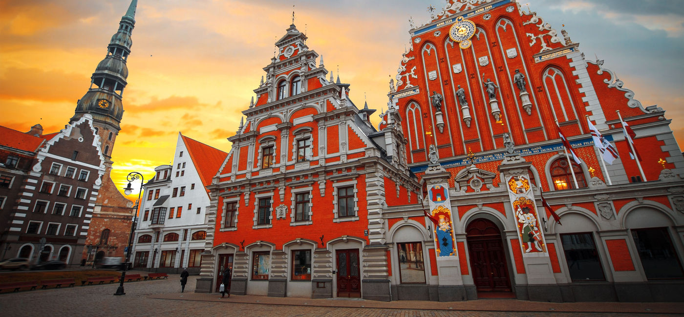 Photo: City Hall Square with House of the Blackheads and Saint Peter church in Old Town of Riga in the evening, Latvia (photo via Lindrik / iStock / Getty Images Plus)