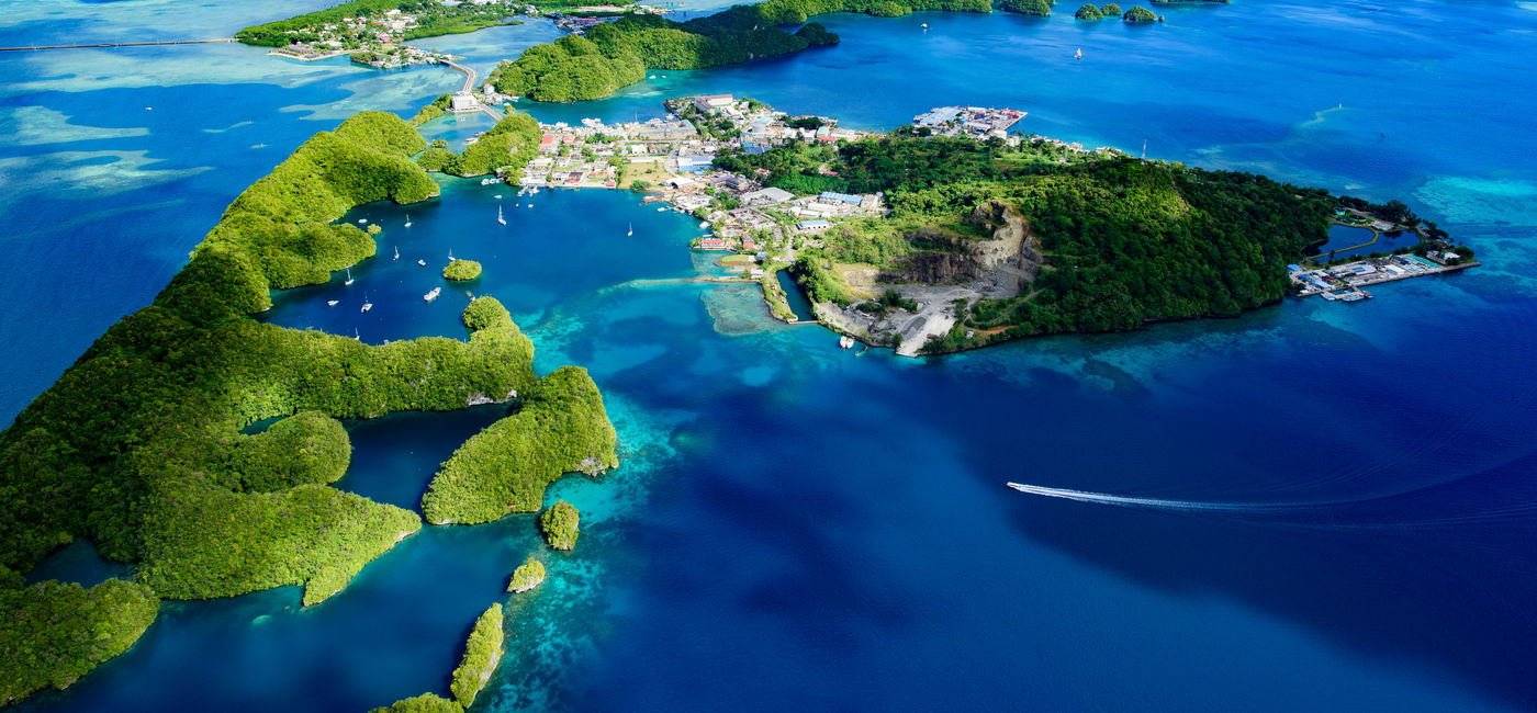 Image: PHOTO: Full view of Palau Malakal Island and Koror in Micronesia. (photo via Norimoto / iStock / Getty Images Plus)