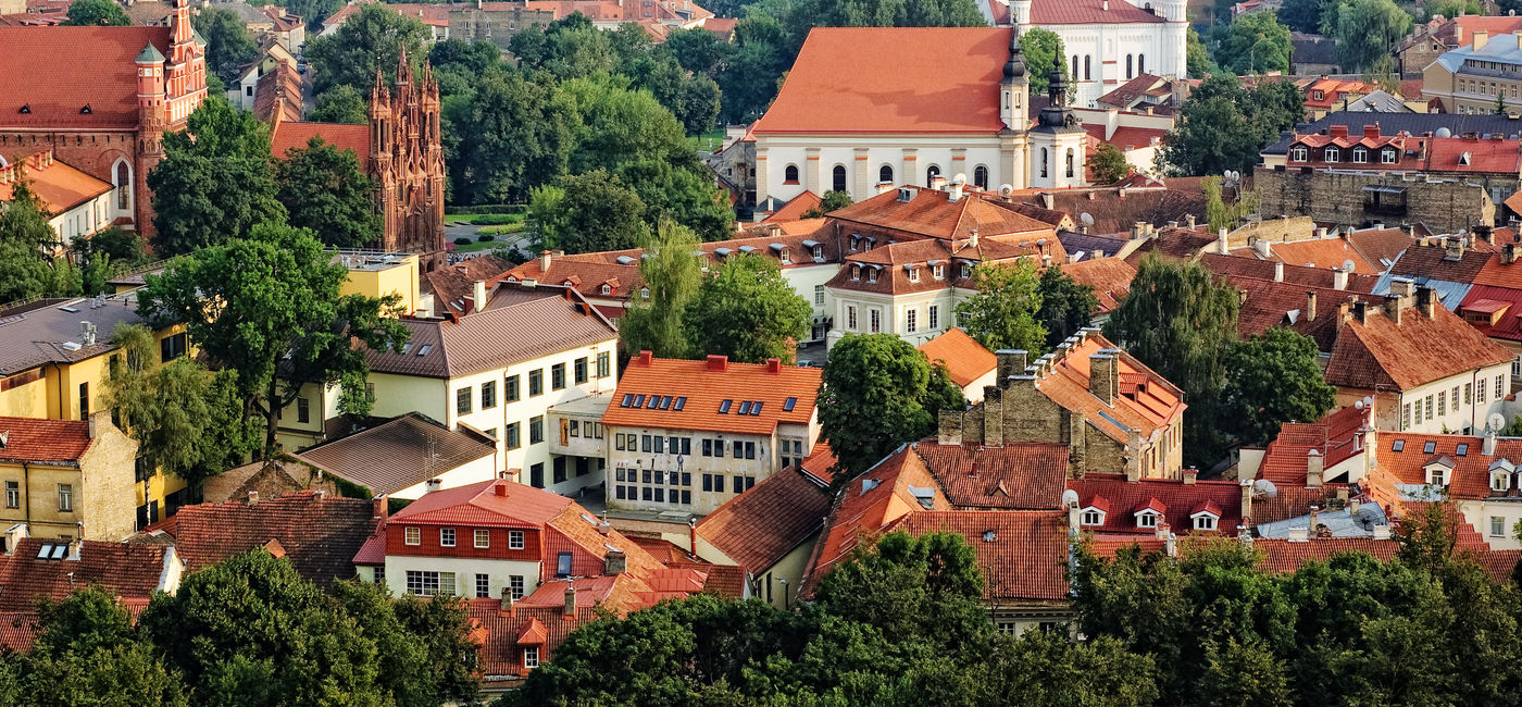 Image: Bird's eye view of Vilnius old town from Gediminas' Tower, Lithuania. (photo via iiokua / iStock / Getty Images Plus)
