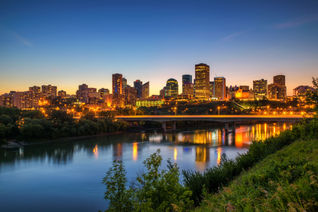 Edmonton downtown, James Macdonald Bridge and the Saskatchewan River at night, Alberta, Canada. Long exposure. (photo via miroslav_1 / iStock / Getty Images Plus)