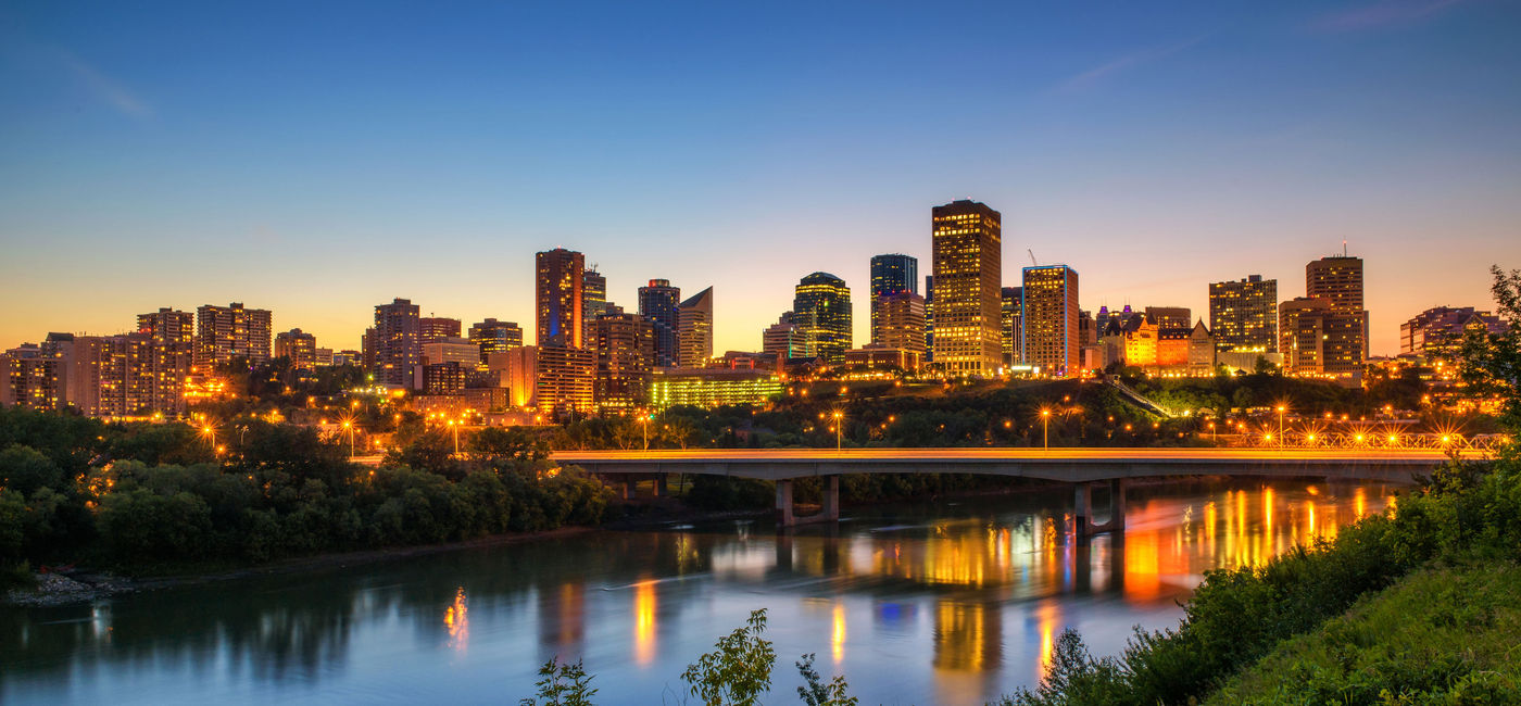 Image: Edmonton downtown, James Macdonald Bridge and the Saskatchewan River at night, Alberta, Canada. Long exposure. (photo via miroslav_1 / iStock / Getty Images Plus)