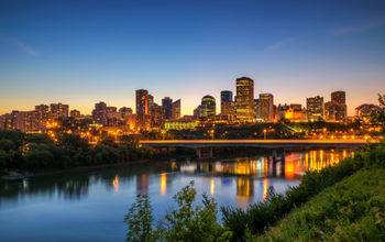 Edmonton downtown, James Macdonald Bridge and the Saskatchewan River at night, Alberta, Canada. Long exposure. (photo via miroslav_1 / iStock / Getty Images Plus)