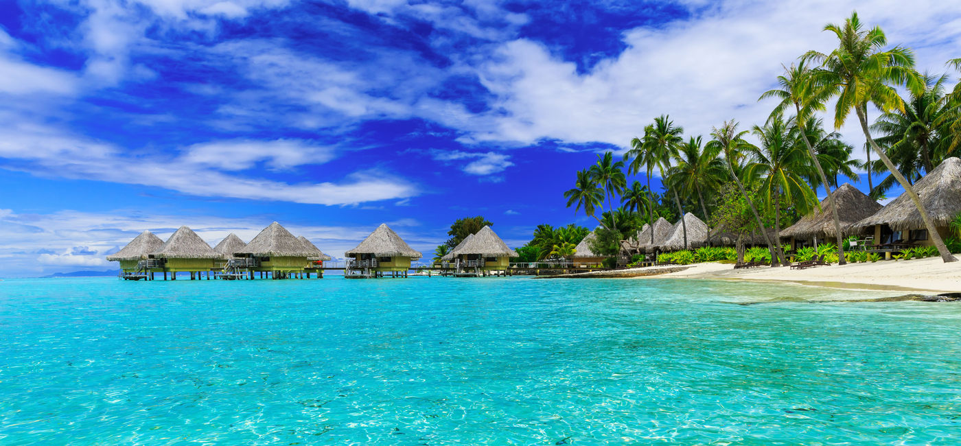 Image: Over-water bungalows of luxury tropical resort, Bora Bora island, near Tahiti, French Polynesia, Pacific ocean (Photo via sorincolac / iStock / Getty Images Plus)