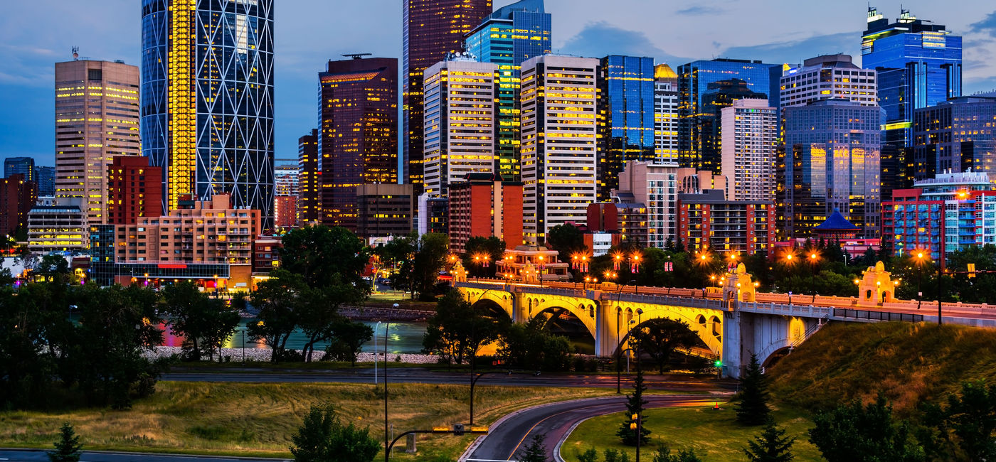 Image: Calgary's skyline by night. (photoquest7 / iStock / Getty Images Plus)