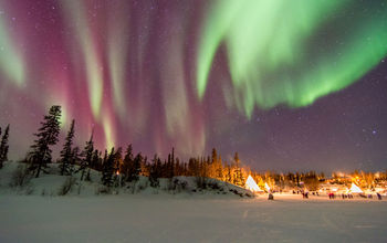 Aurora over scenes in Yellowknife (NZSteve / iStock / Getty Images Plus)