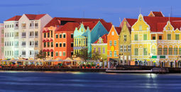 View of downtown Willemstad at twilight. Curacao, Netherlands Antilles (Photo via sorincolac / iStock / Getty Images Plus)