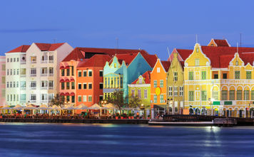 View of downtown Willemstad at twilight. Curacao, Netherlands Antilles (Photo via sorincolac / iStock / Getty Images Plus)