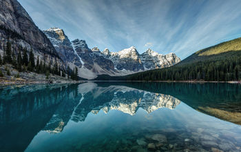 Moraine Lake reflection on a calm morning in Banff National Park, Alberta, in the heart of the Canadian Rockies. (photo via P_L_photography/iStock/Getty Images Plus)
