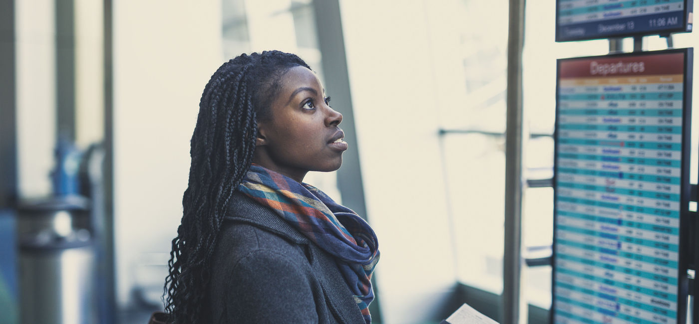Image: Young woman at airport. (Credit:Fat Camera/Getty Images)