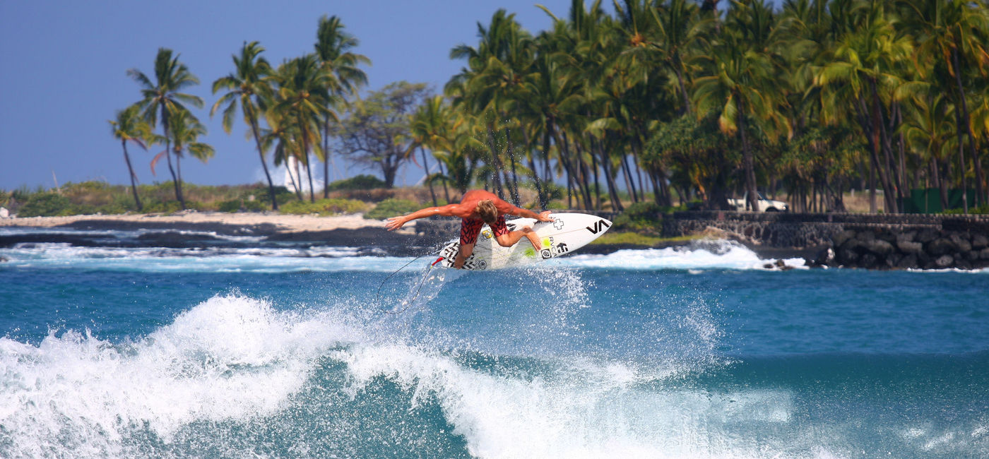 Image: Surfing on Hawai'i Island. (Photo via Hawaii Tourism Authority (HTA) / Kirk Aeder)