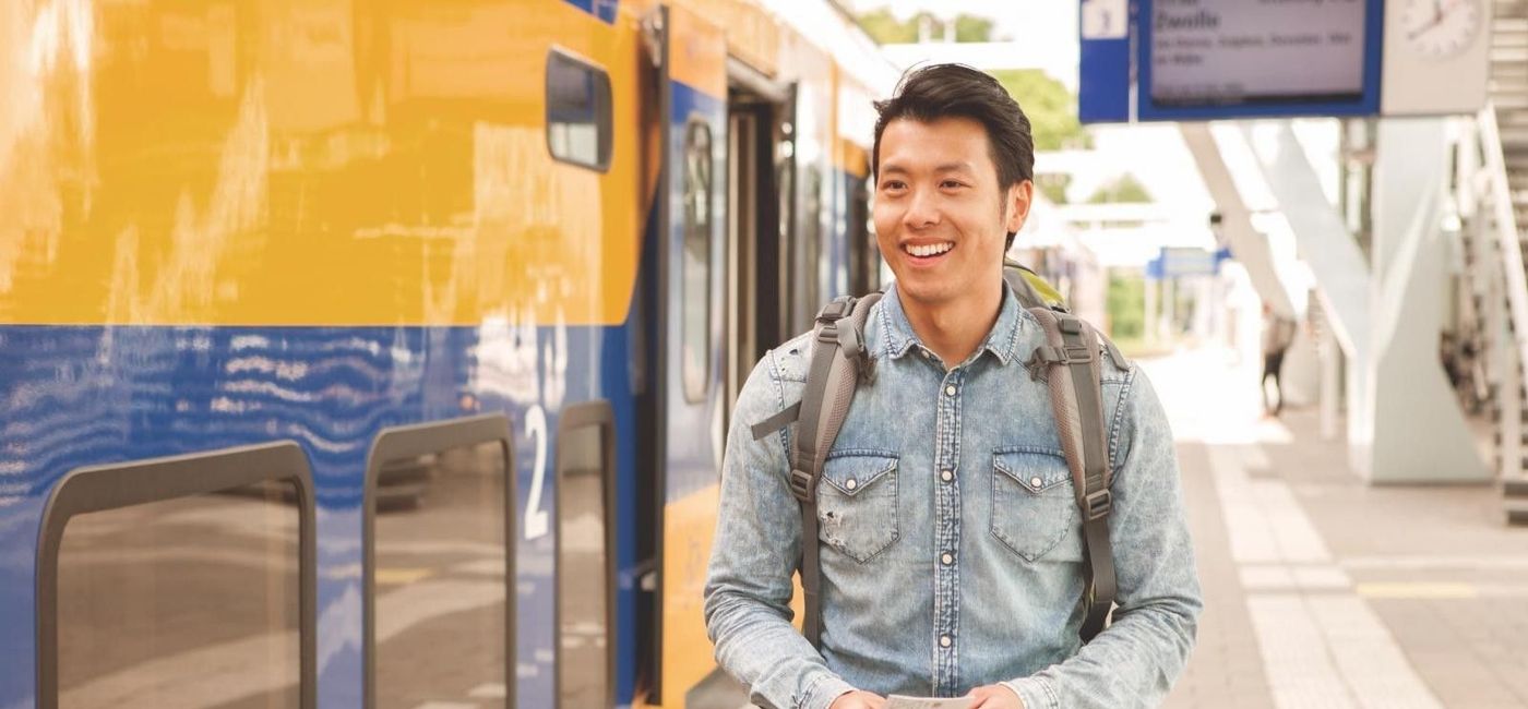 Image: Traveler at a train station in Europe. (Photo via Eurail)