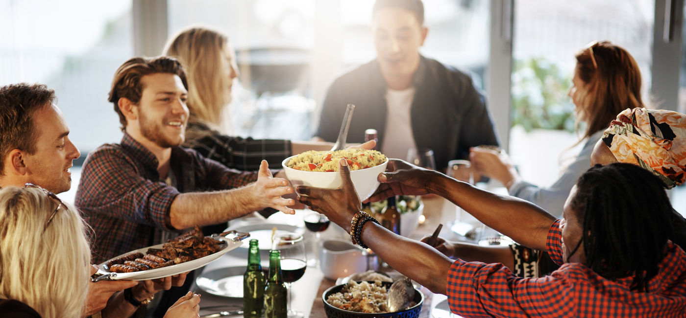 Image: Celebrating with friends over a meal. (Photo via iStock / Getty Images E+ / Tinpixels)