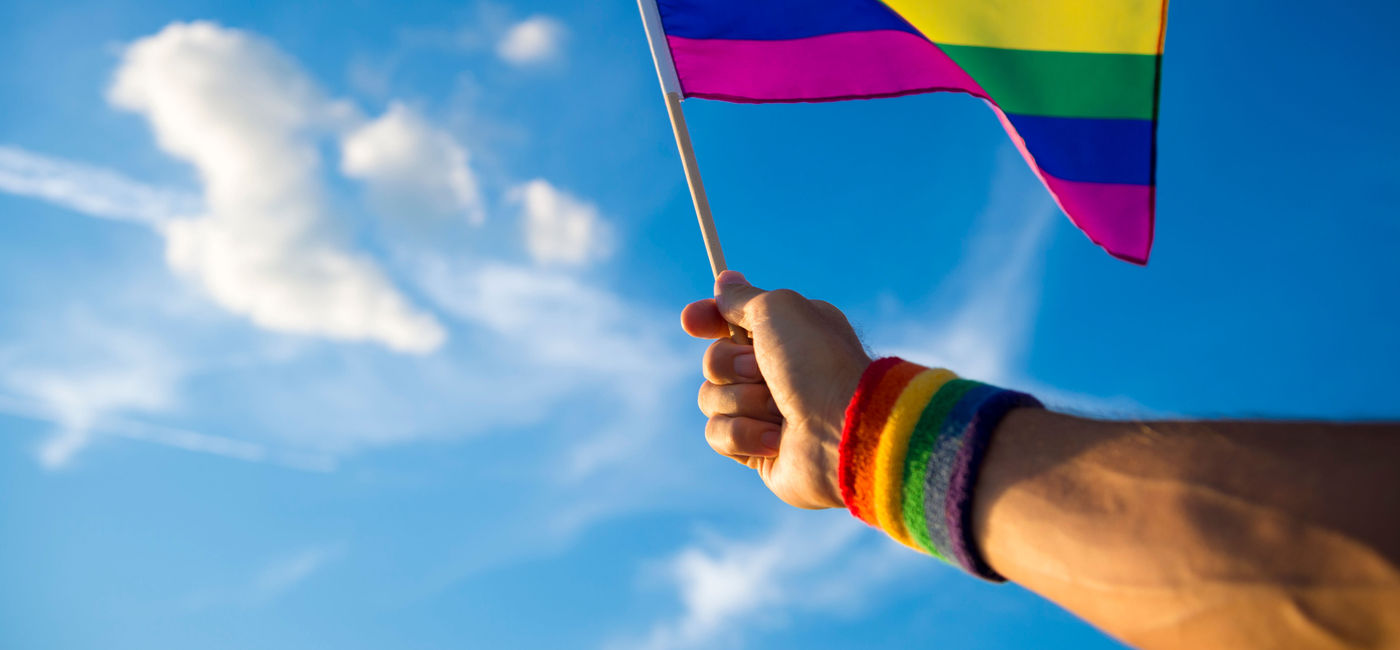 Image: Someone waves an LGBTQ flag. (photo via Riviera Nayarit)