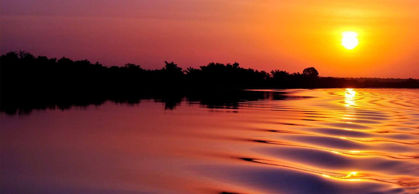 Image: PHOTO: Sunset on the Gambia River (photo courtesy kacof/iStock/Getty Images Plus)
