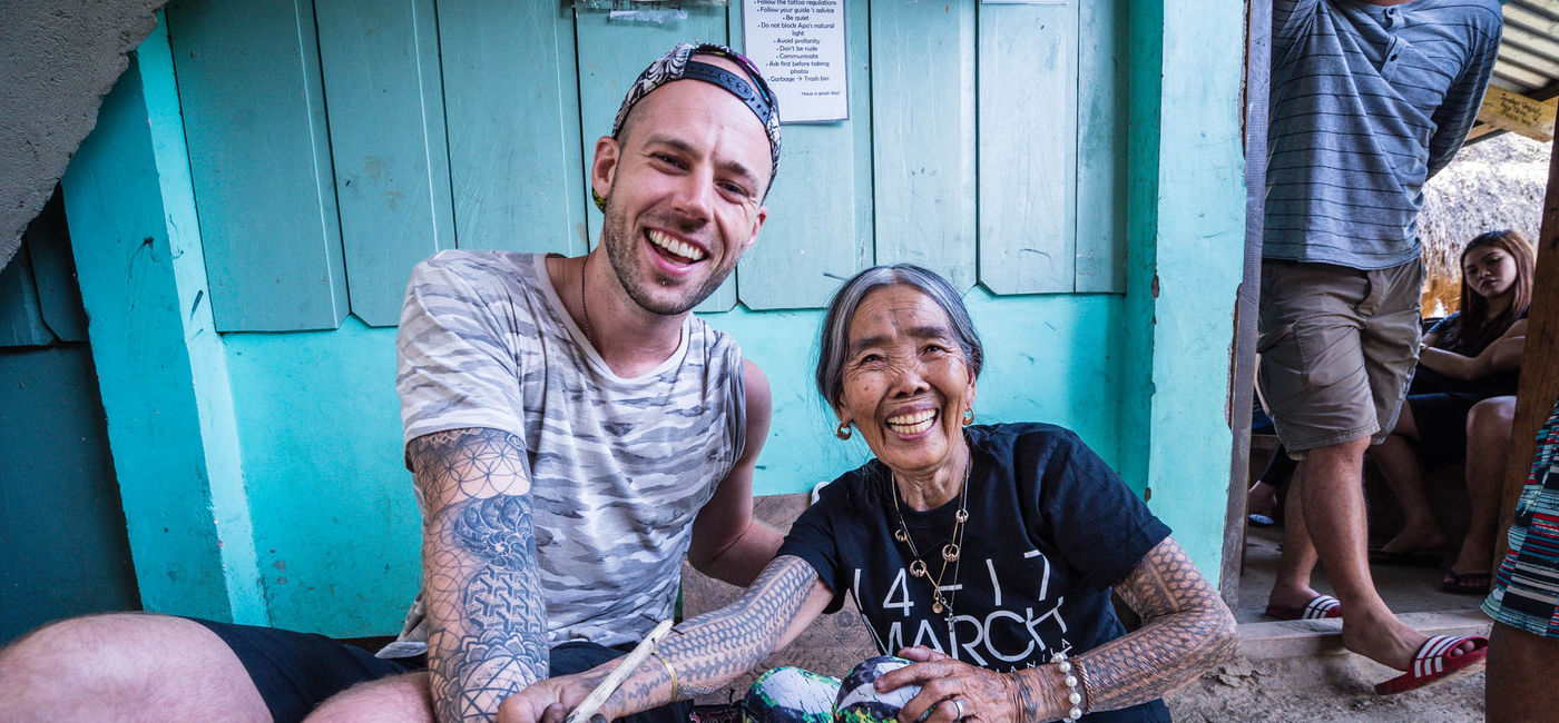 Image: PHOTO: Mike Corey with Whang-od Oggay, the last and oldest practitioner of Kalinga tattooing in the Philippines. (photo courtesy of Mike Corey of Fearless and Far)