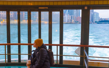 Woman sitting on a cruise ship in Tokyo Bay, Japan.