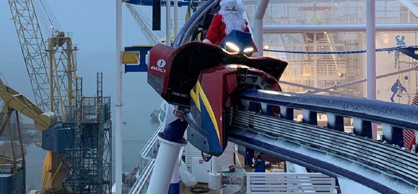 Image: Santa Claus test rides the BOLT roller coaster on Carnival's new Mardi Gras. (Photo via Carnival Cruise Line)