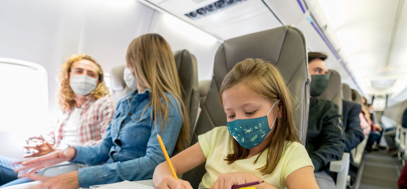 Image: Family traveling on busy plane. (photo via Hispanolistic / E+)