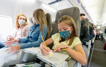 Family traveling on busy plane.