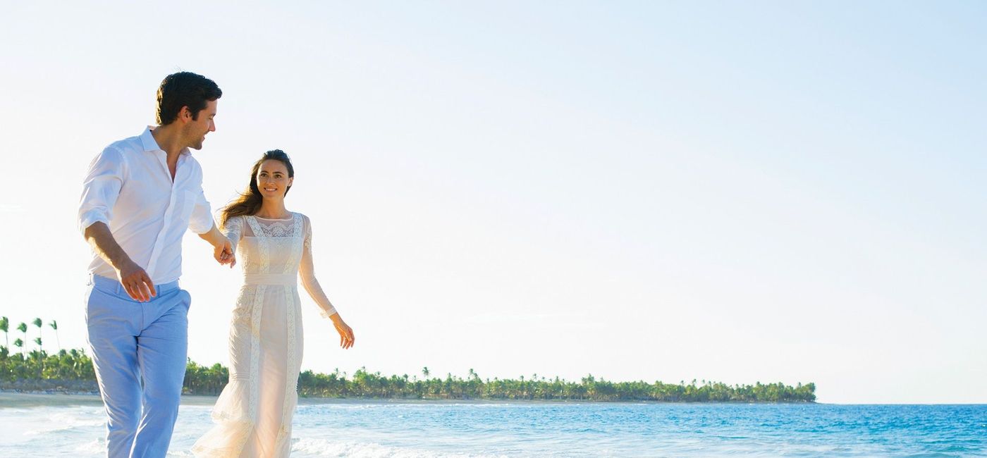 Image: A couple on the beach. (photo via The Excellence Collection)