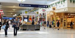 Passengers walking by shops at Minneapolis-St Paul International Airport