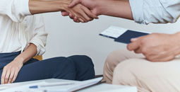 Travel agent shaking hands