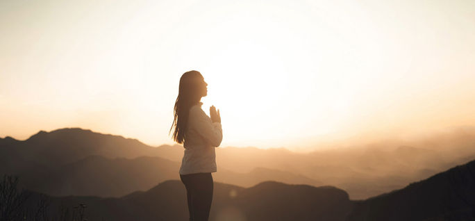 A woman practices gratitude in the mountains. gratitude, thankfulness, meditation