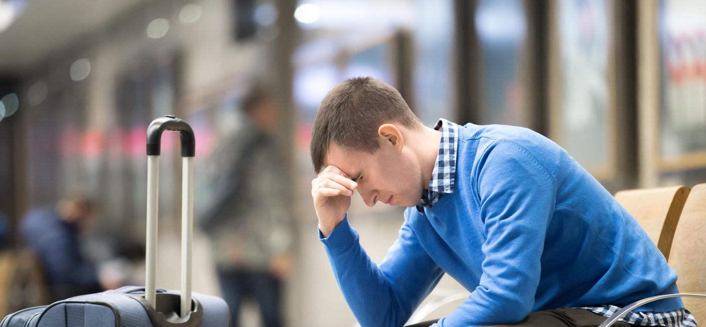 Photo: A frustrated traveler at the airport. (photo via fizkes/iStock/Getty Images Plus)