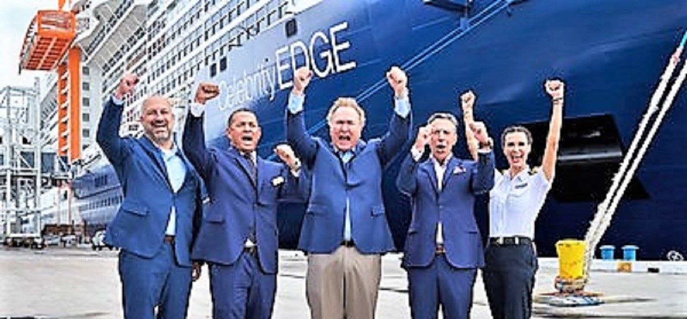Image: Royal Caribbean Group CEO Richard Fain (center), Captain Kate McCue *far right) and other officials cheer as the Eelebrity Edge becomes the first ship to set sail from a U.S. port in the post-pandemic era. (Royal Caribbean)