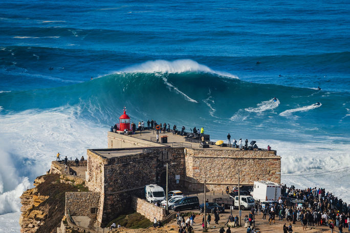 Surfer riding a giant wave in Nazare, Portugal 