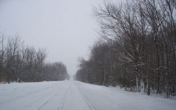 A snow-covered road following a massive storm. 