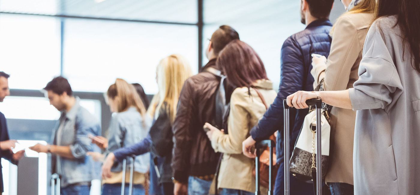 Image: Passengers queued up at an airport boarding gate. (Photo via iStock/Getty Images E+/izusek)