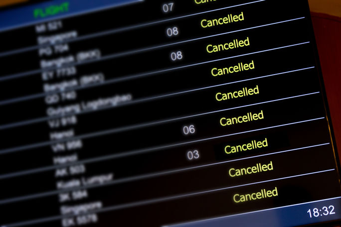 Airport billboard panel with canceled flights.