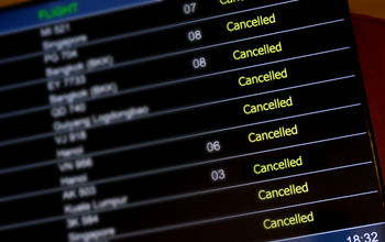 Airport billboard panel with canceled flights.
