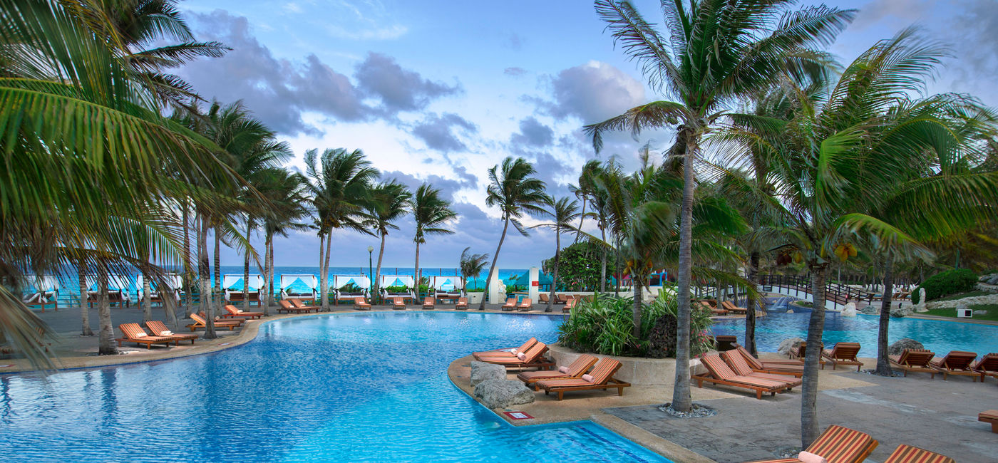 Image: PHOTO: Poolside relaxation. (photo via Oasis Hotels & Resorts)