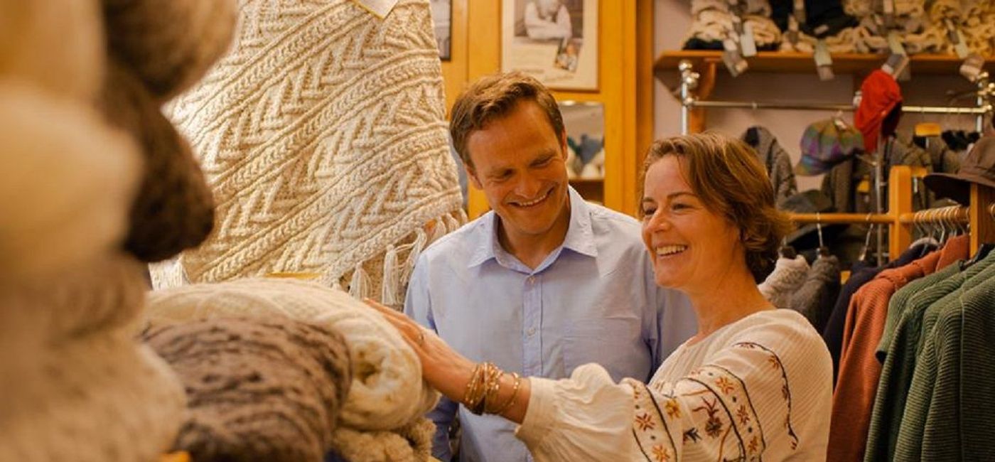 Image: A couple looking at sweaters and blankets in Ireland (photo via CIE Tours) (CIE Tour)