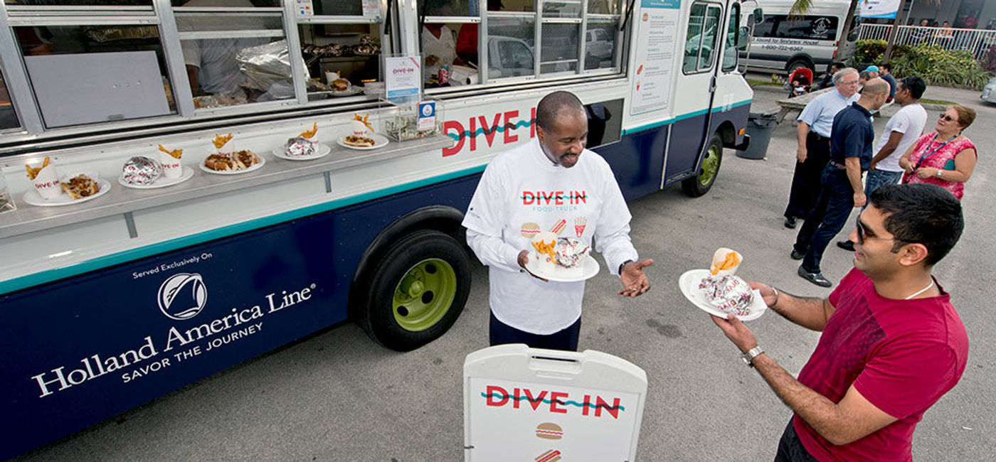 Image: PHOTO: Orlando Ashford serves Dive-In grill items from Holland America Line's food truck at Seatrade Cruise Global 2016. (Photo courtesy of Andy Newman/Holland America Line)