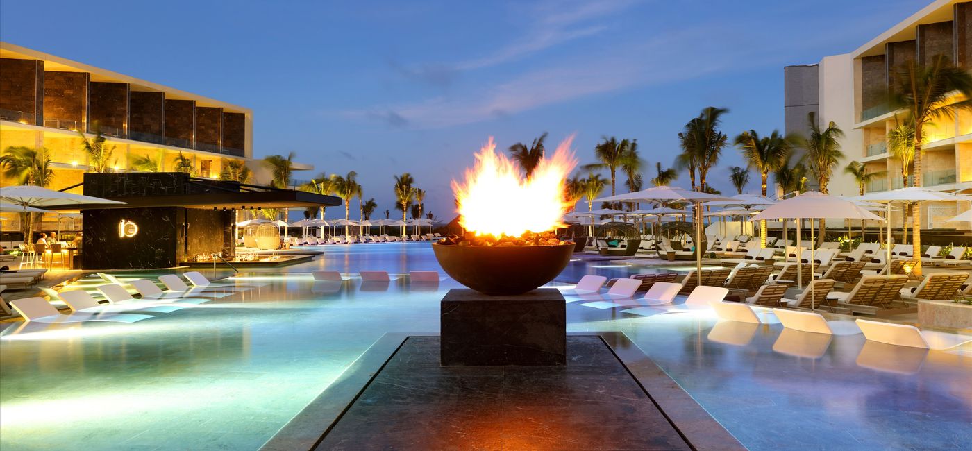 Image: The TRS Coral Hotel's main swimming pool at dusk, Costa Mujeres, Mexico. (Source: Wyndham Hotels & Resorts)